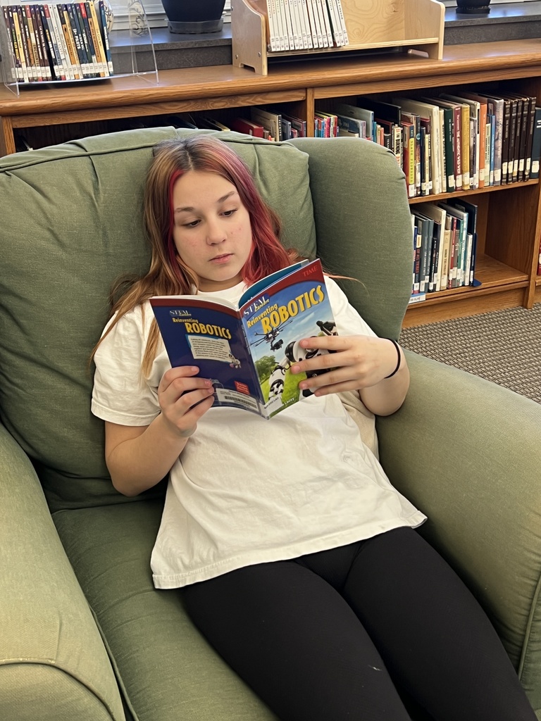 Reading a book on Robotics.