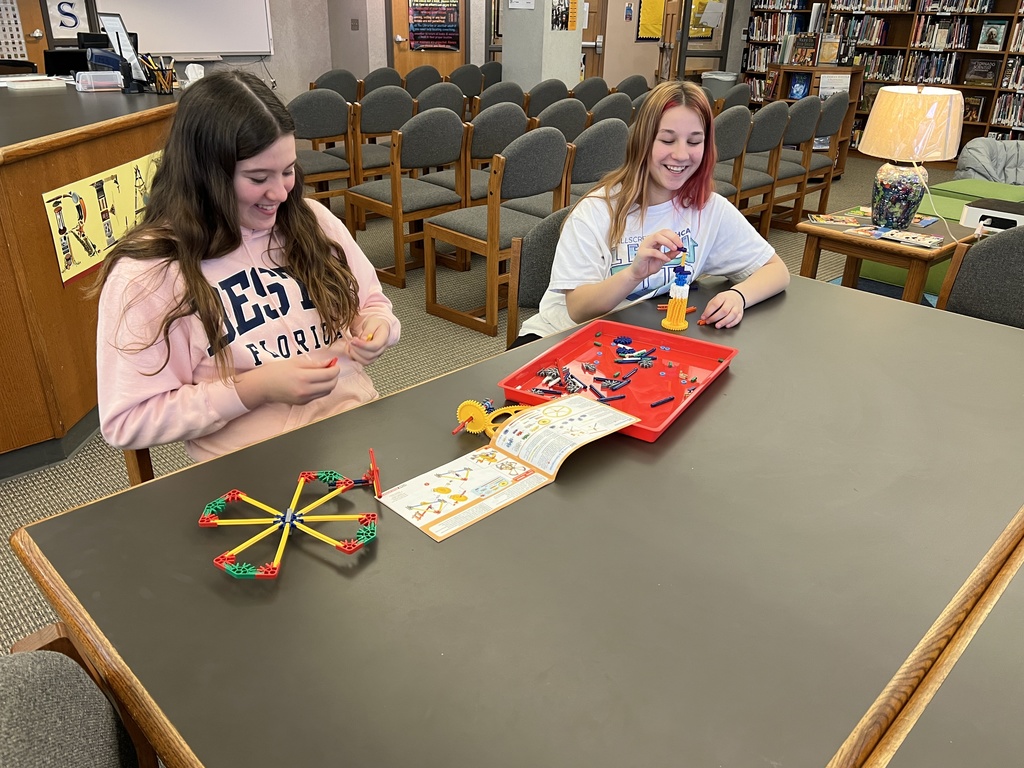 Girls working together to build with KNex.