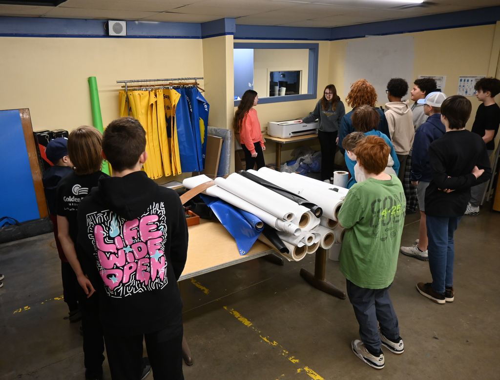 Students learn about making banners in graphic design.