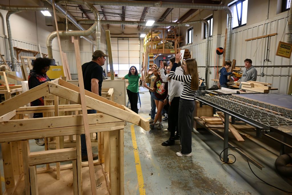 Students learn from Jim Gilpin about carpentry and woodworking.