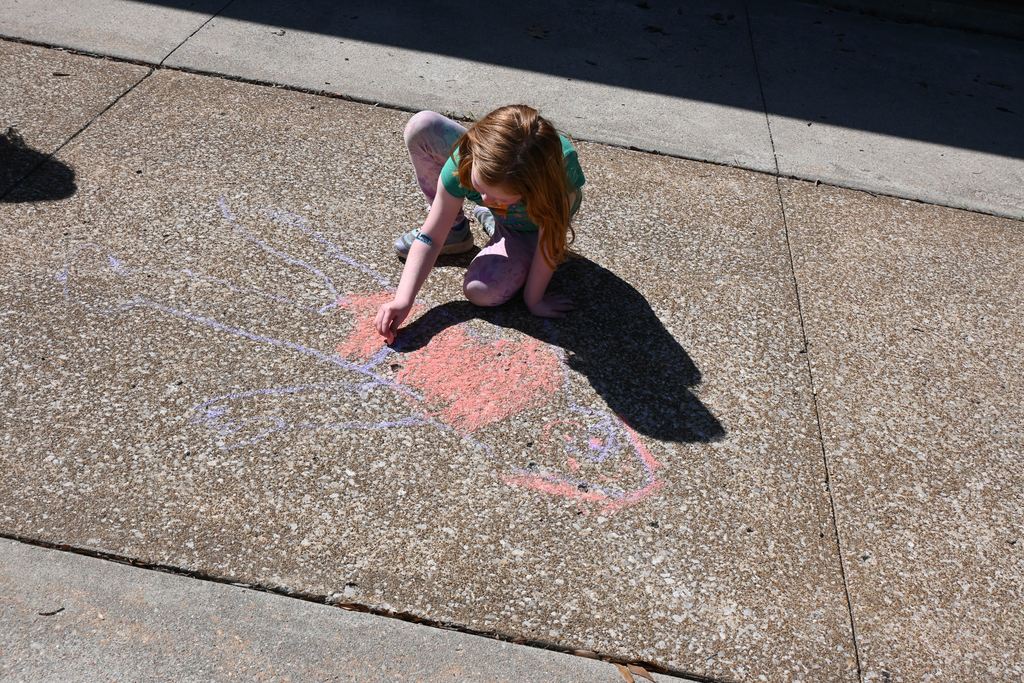 A student colors in her shadow outline.