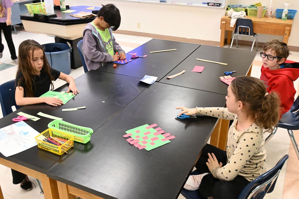 A table of students have finished the first part of their project..