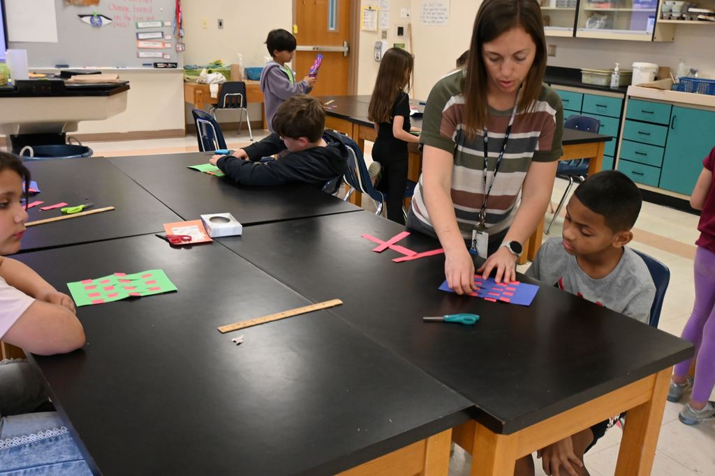 Mrs. Hunn guides a student in over and under technique.