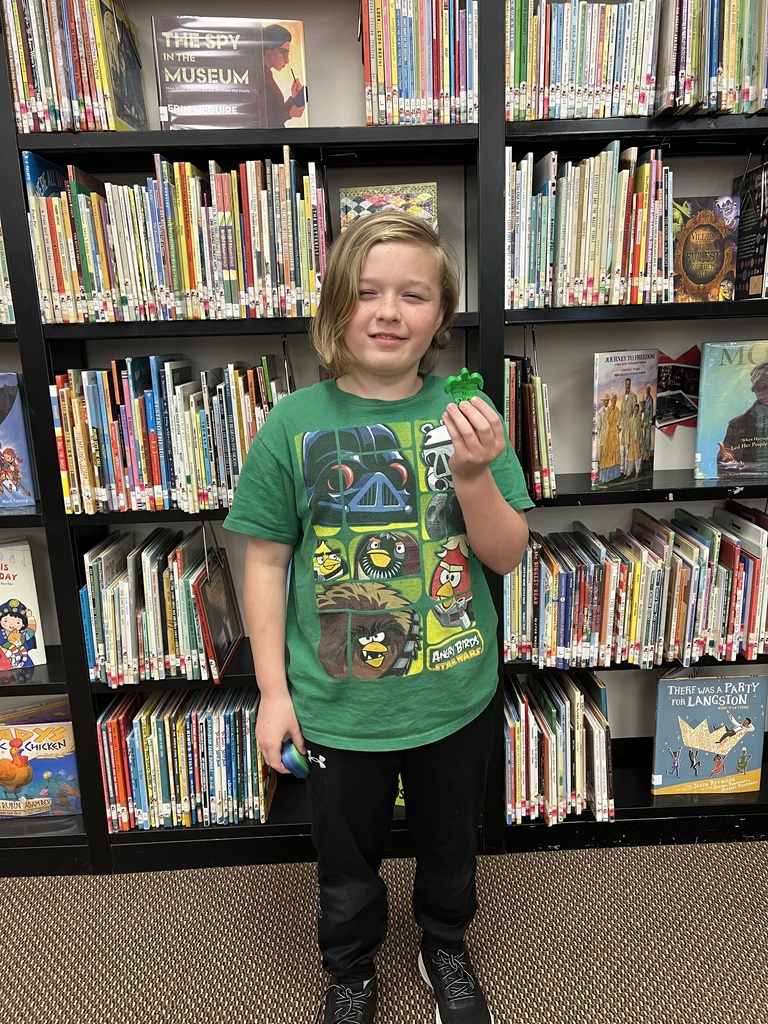 Student receives Beg. Review 2 prize in Mrs. Shields' class.