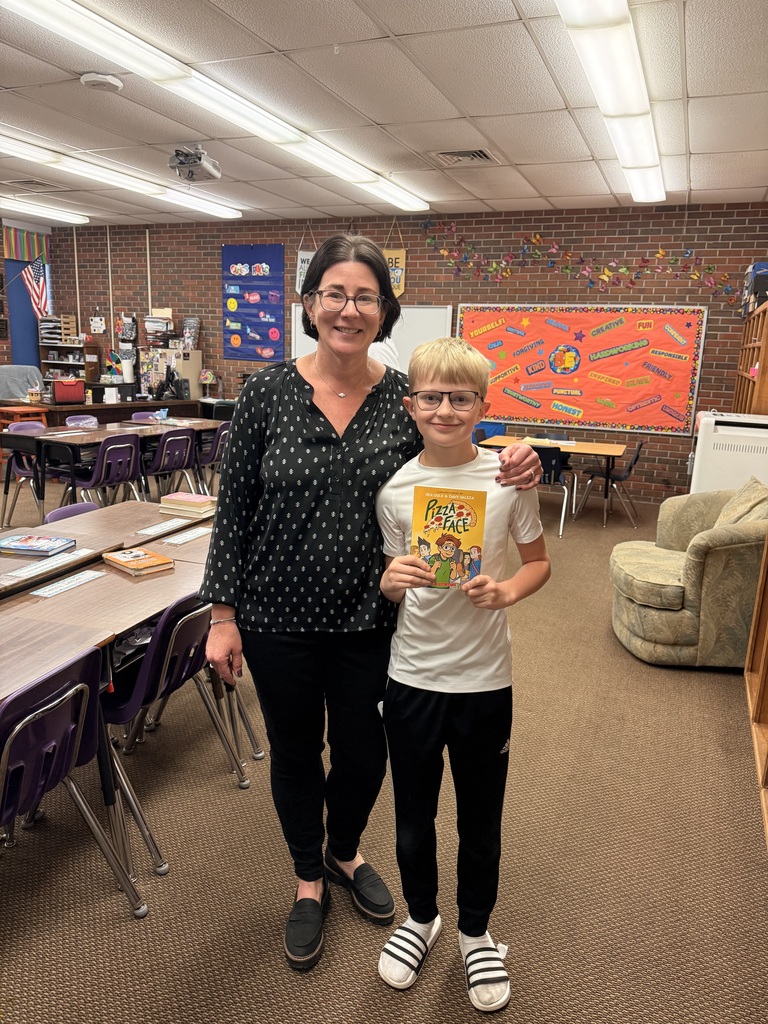 Mrs. Armstrong being gifted books for her classroom.