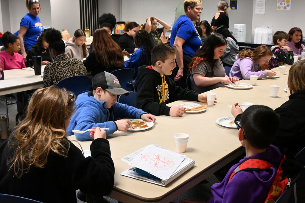 Students enjoy a pancake breakfast.