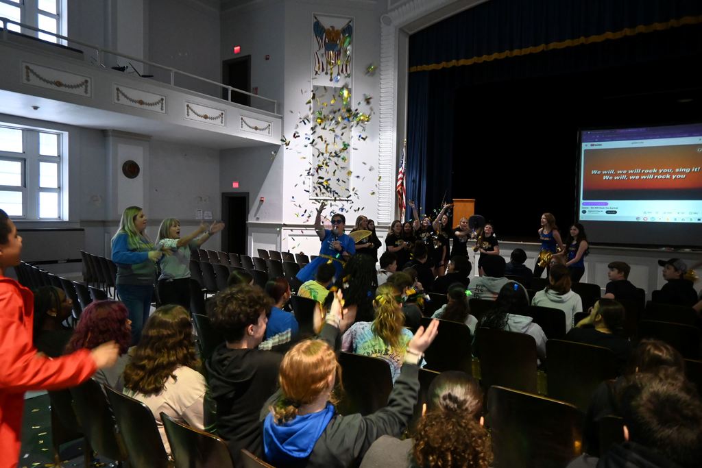 The Testing Fairy throws "knowledge dust" (confetti) over the students