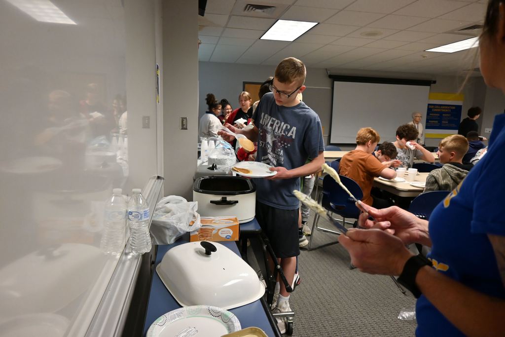 Students get pancakes for breakfast in the community room.