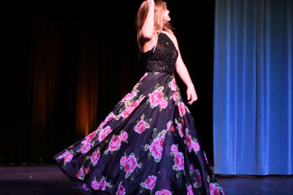 A girl models a prom dress.