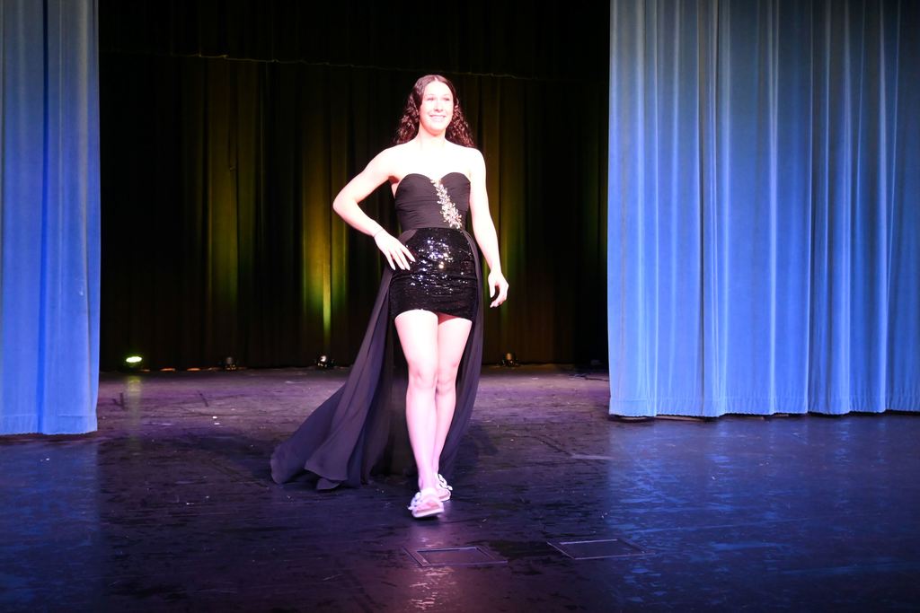 A girl models a prom dress.