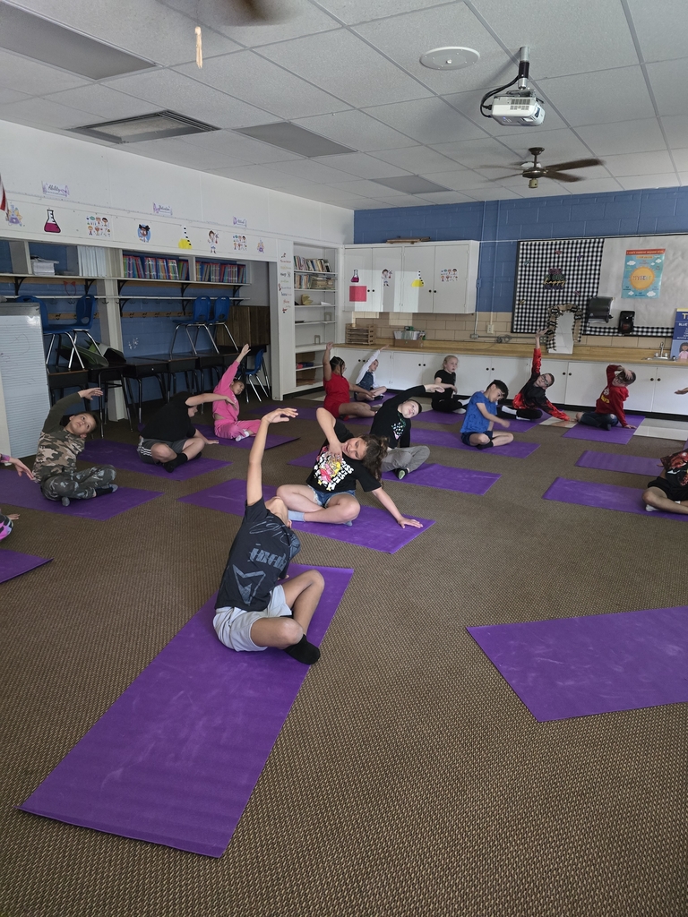 students stretching overhead