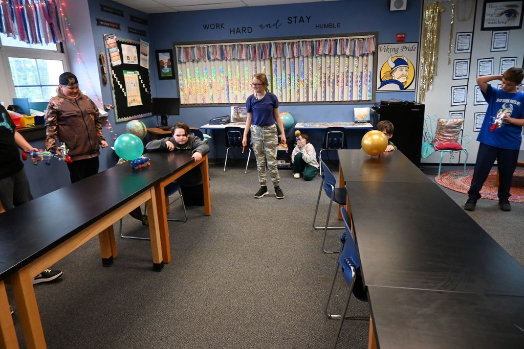 Two students race their cars.