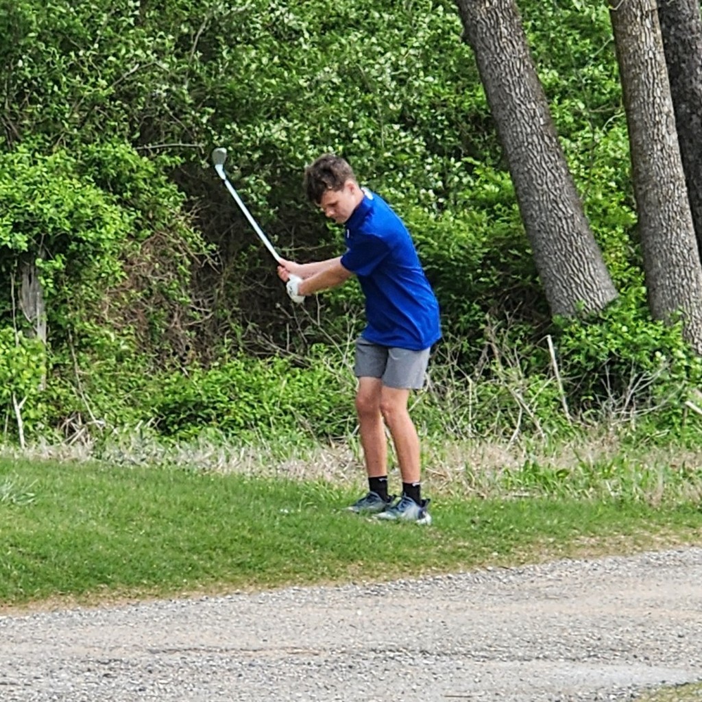 Kaison McRay chipping over the road behind number 1 green.