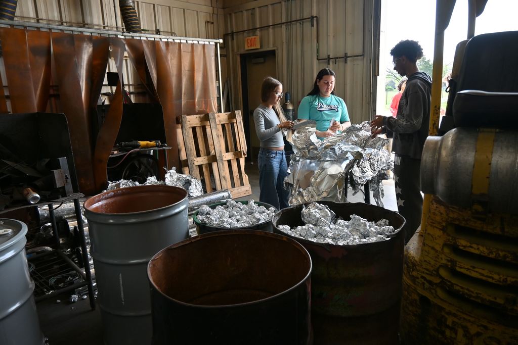 Welding students spend free time rolling thin aluminum into balls to sell as scrap metal.