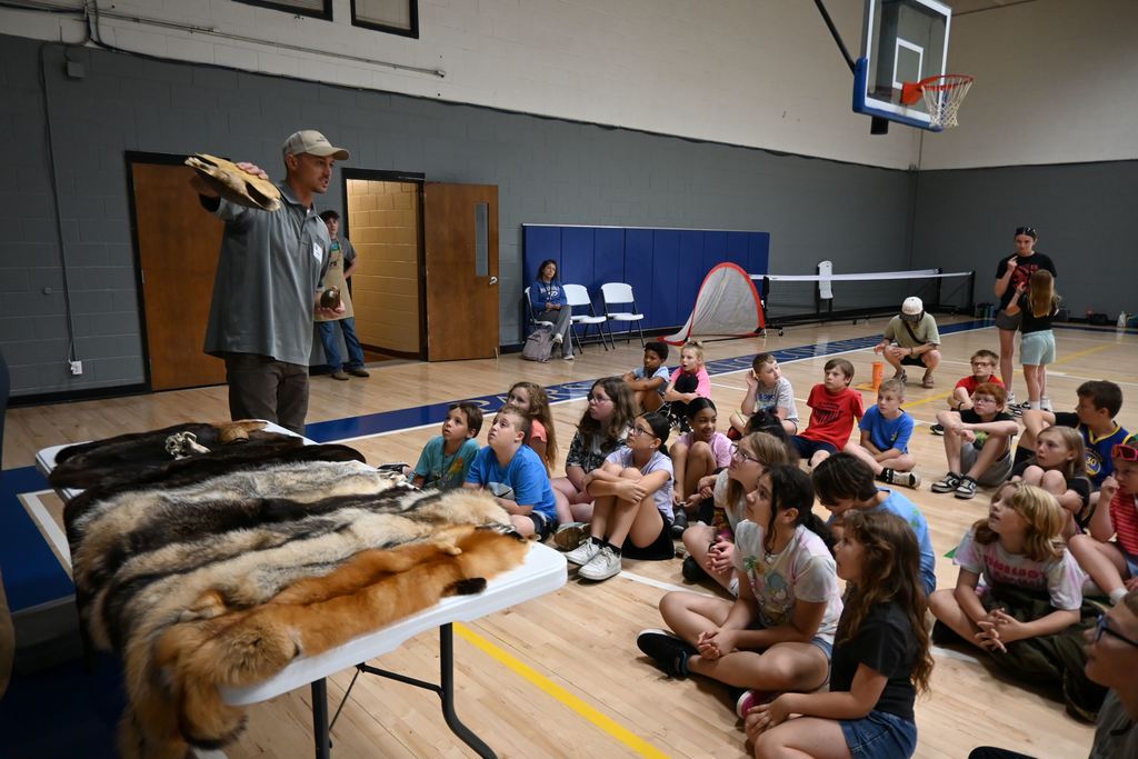 Dtudents are shown the shells of some different Kansas turtles.