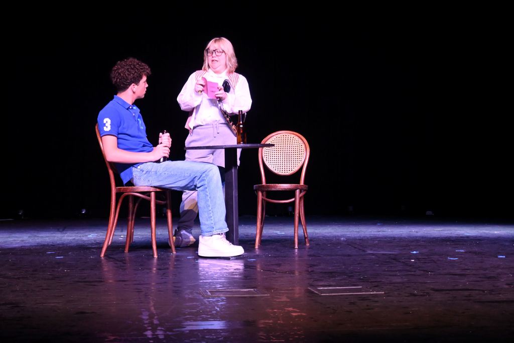 A woman takes a man's order.