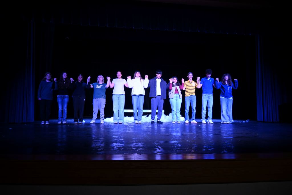 Students line the stage for curtain call.