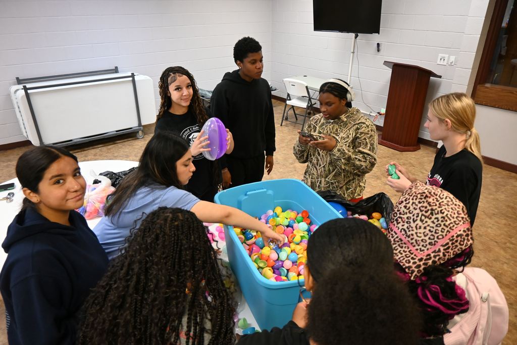 Students sort Easter eggs  removing broken ones and pairing tops to bottoms.