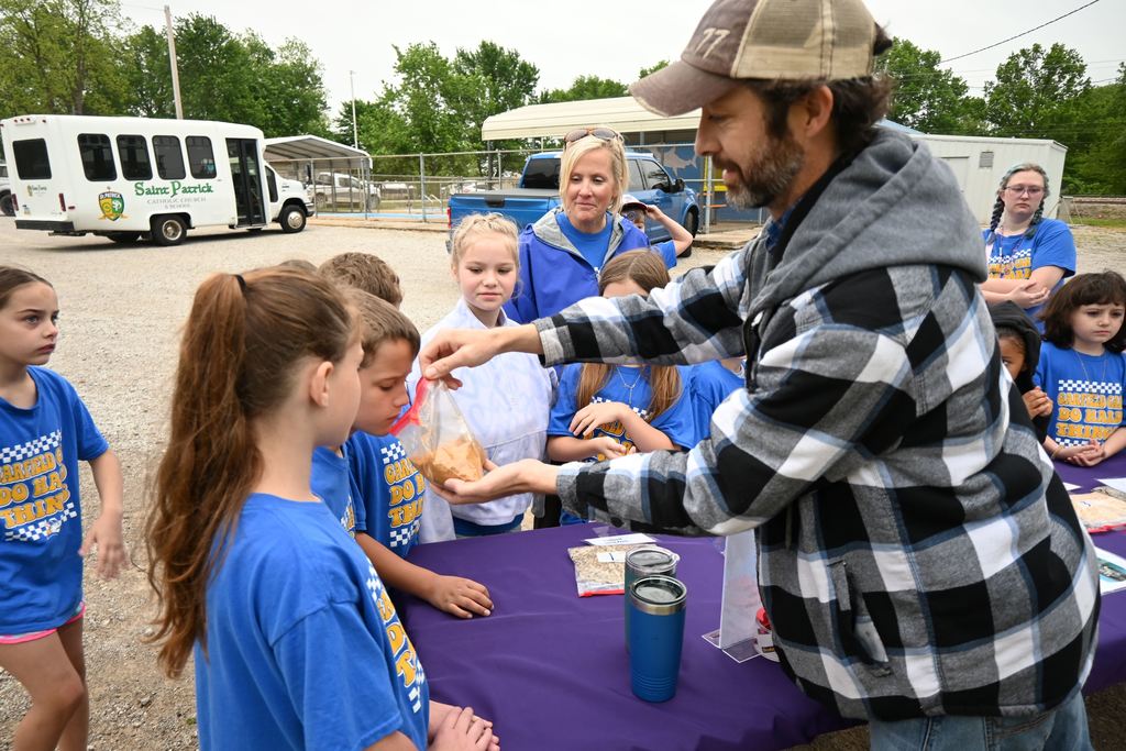 Students smell one of the grain crops.