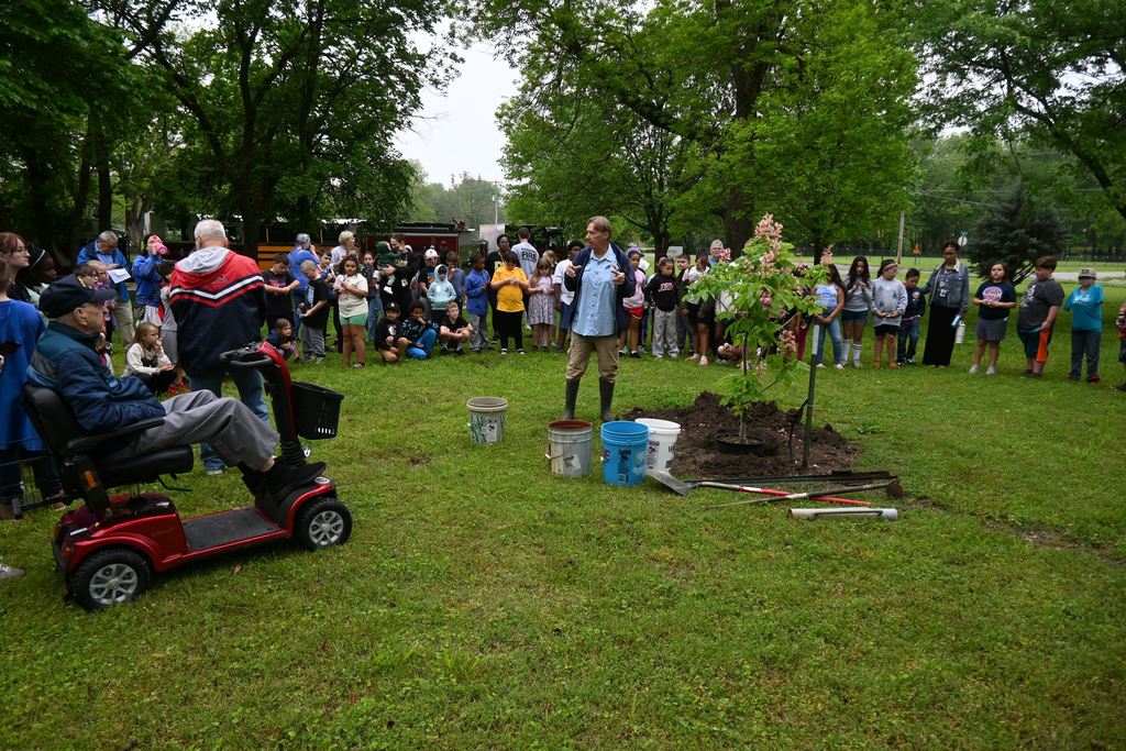 Students watch as a tree is planted at the arboretum in honor of Arbor Day 2026.