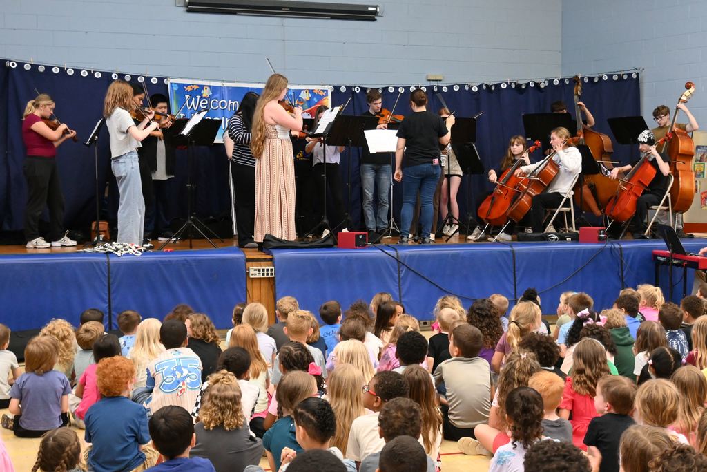 The orchestra plays for Lincoln students.