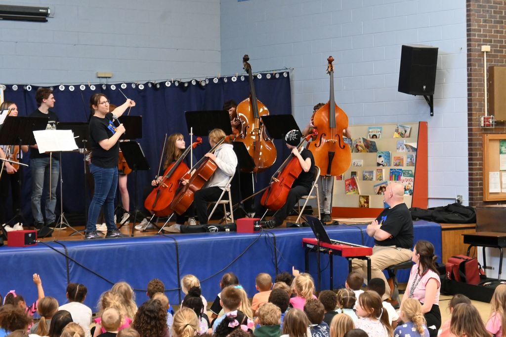 The bass players hold up their instruments.