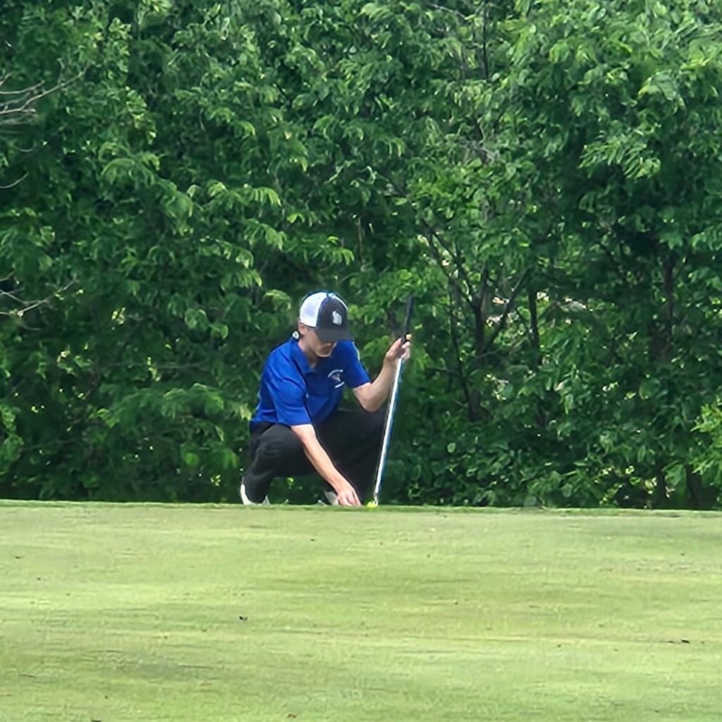 Brok lining up his putt on six from the edge of the fringe.
