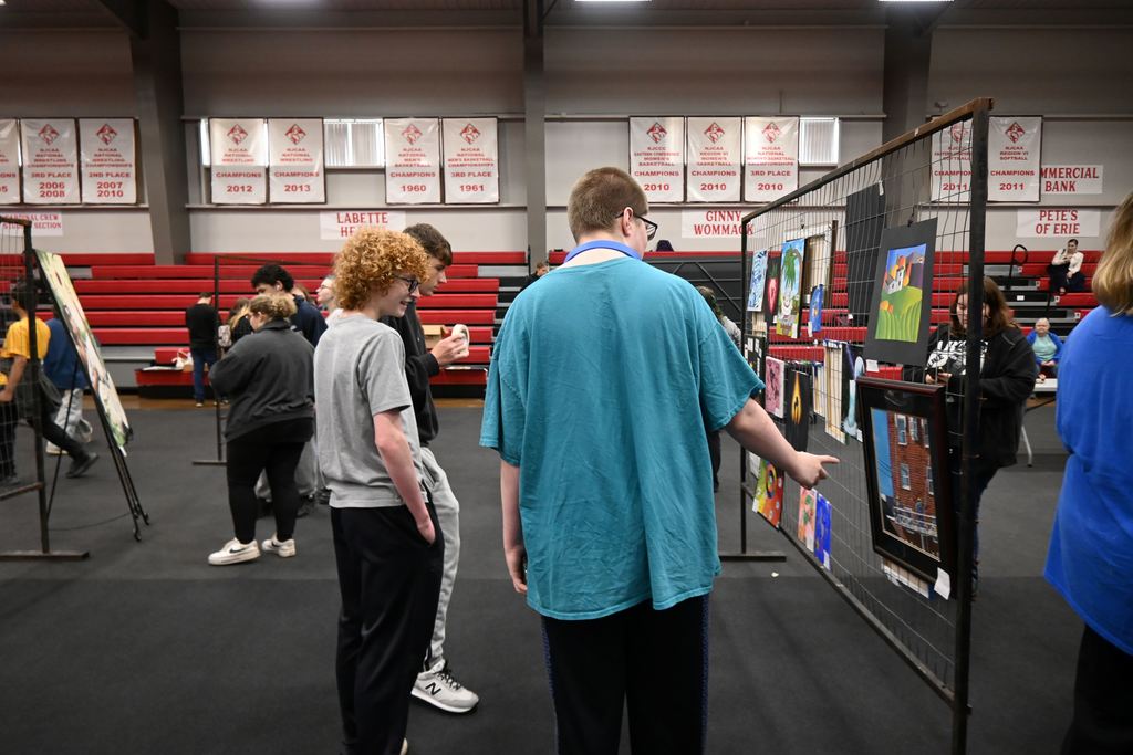 Students check out art from other schools.