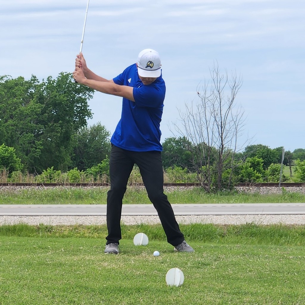 Grayson Bolt mid backswing for his shot over the pond on 8.