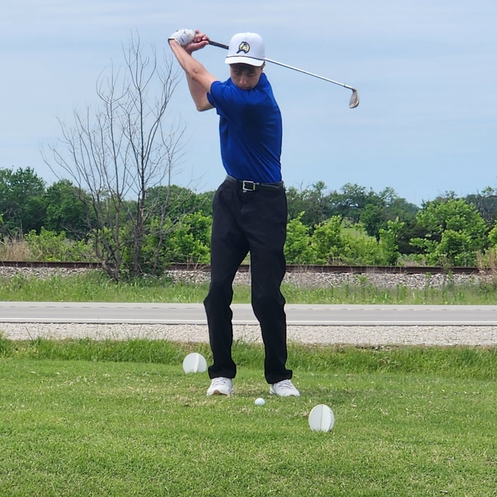Brody Wright hits his shot over the pond on number 8.