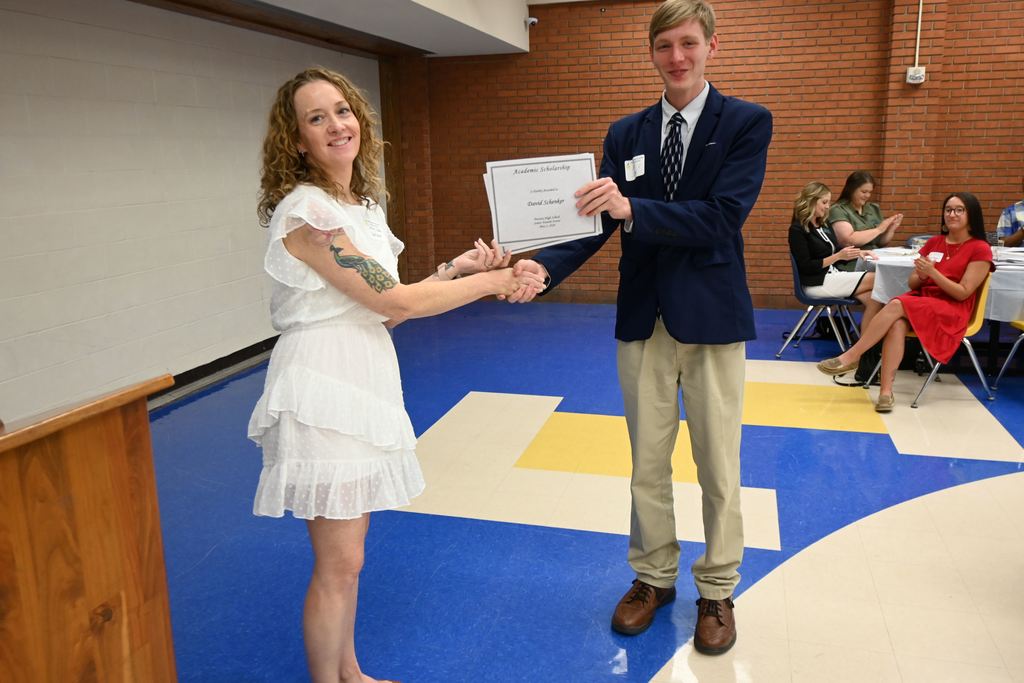 Sally Clay presents a scholarship.