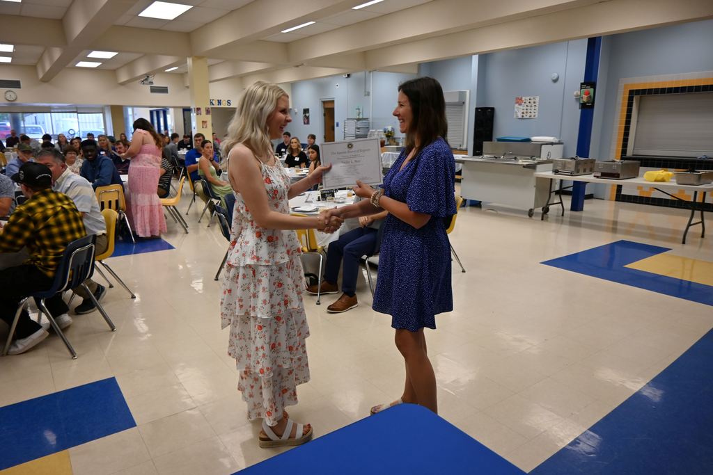 Kylie Lucas presents a scholarship.