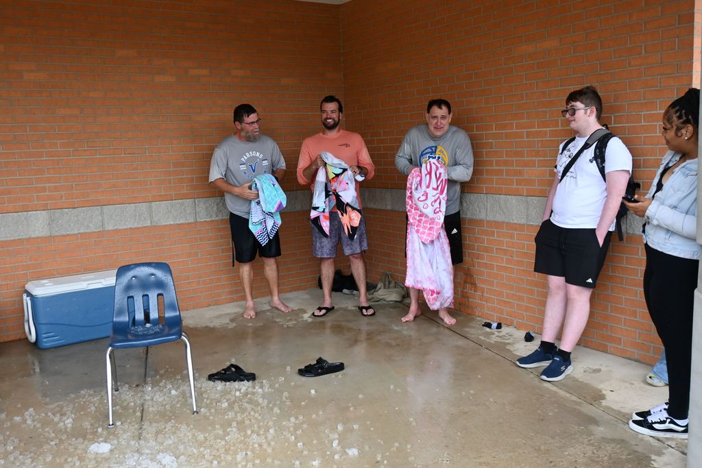 The three volunteers try to dry off to get warmer.