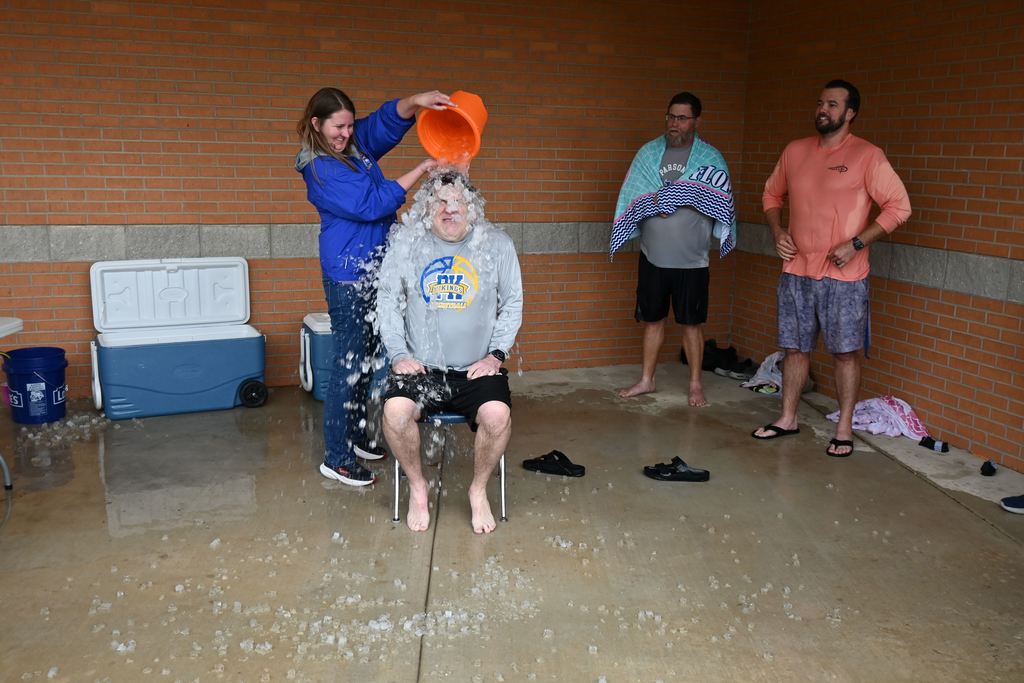 Barcus gets a pail of ice water dumped on his head.