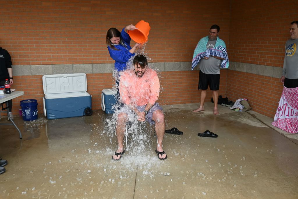 Thompson gets a pail of ice water dumped on him.