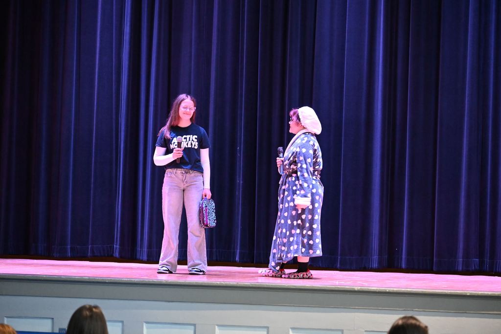 A scene where a student is visited by her mother who is wearing a bathrobe.