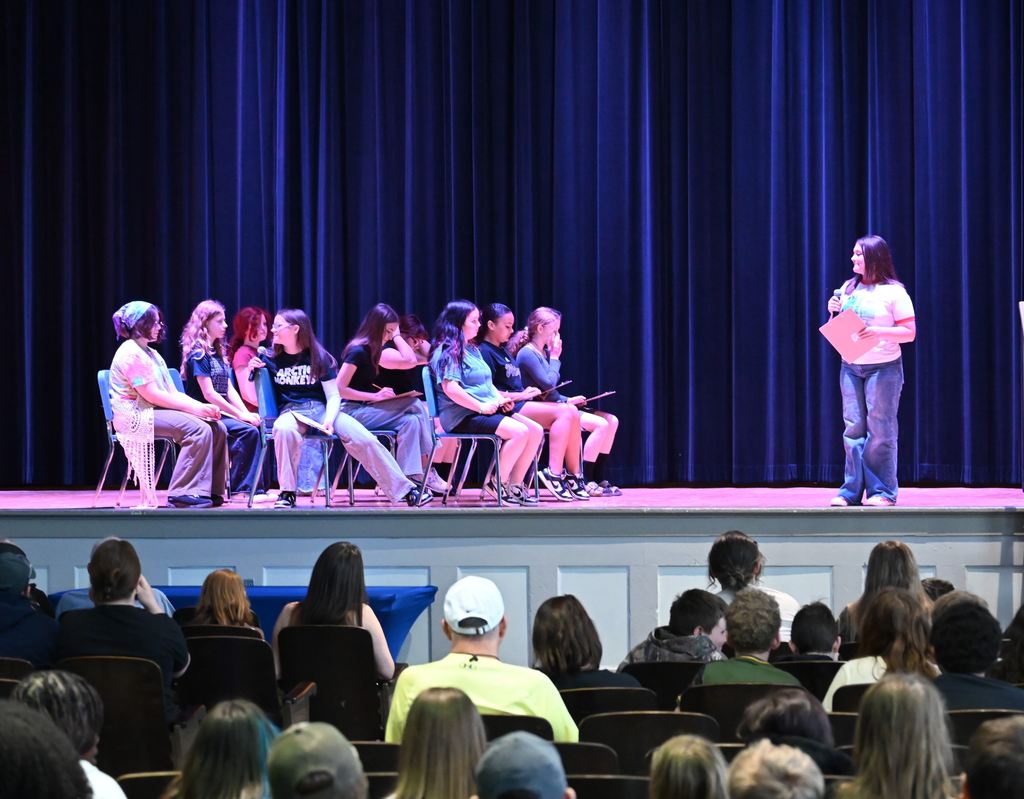 Students act out a scene where they are taking a test.