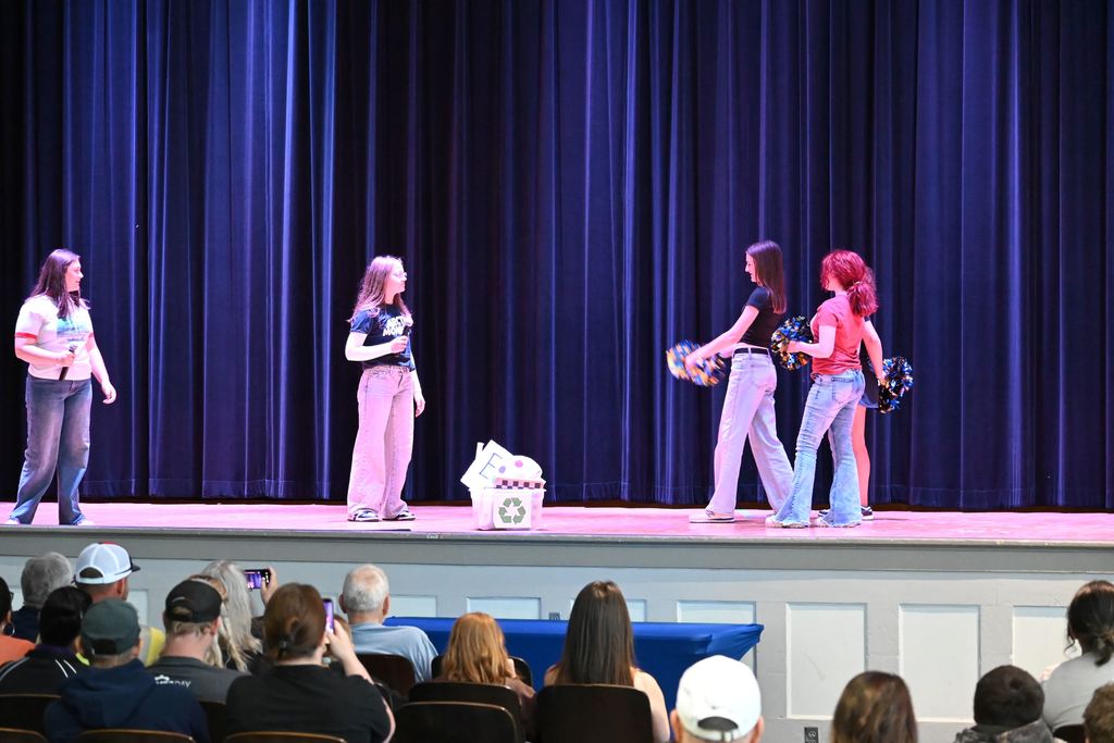 Students act out a scene involving cheer.