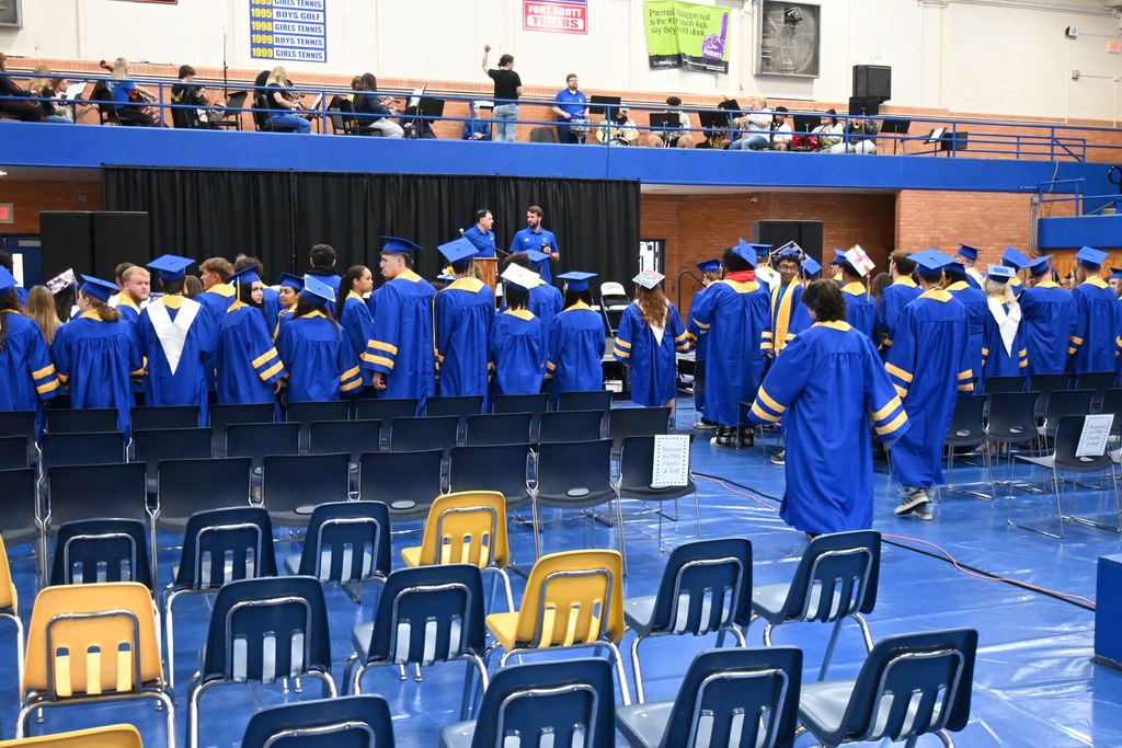 Seniors run through a practice  gradation ceremony.