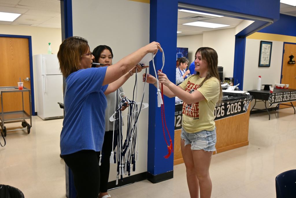 A senior is given her CTE honor cords by Courtney Shafer.