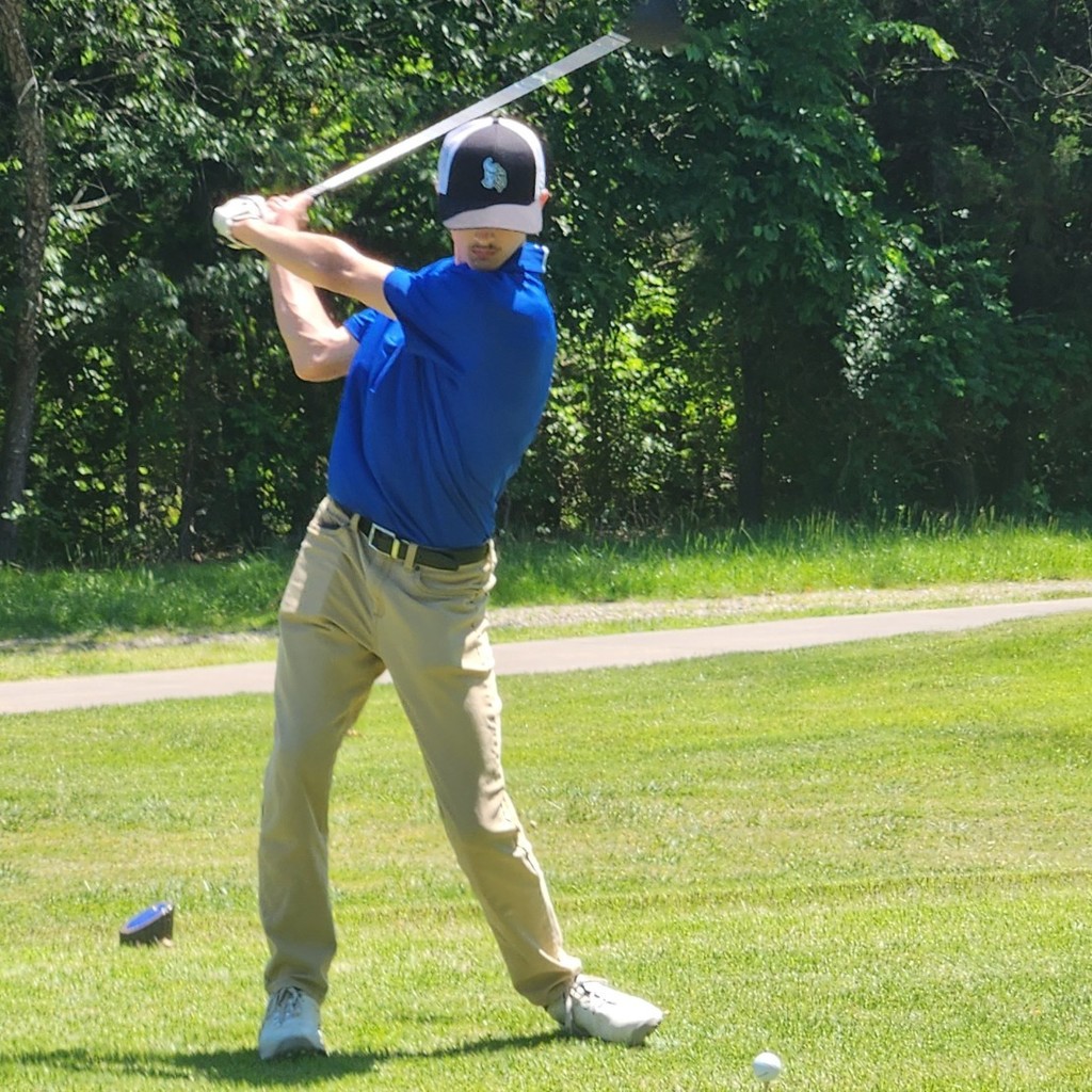 Brok McDaniel mid backswing on number 13 tee box.