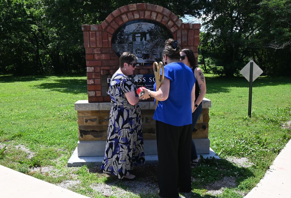 Perkins, chmaber and city reps stand by the memorial.