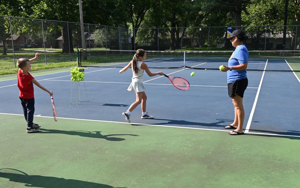 Children practice their forehand swing.