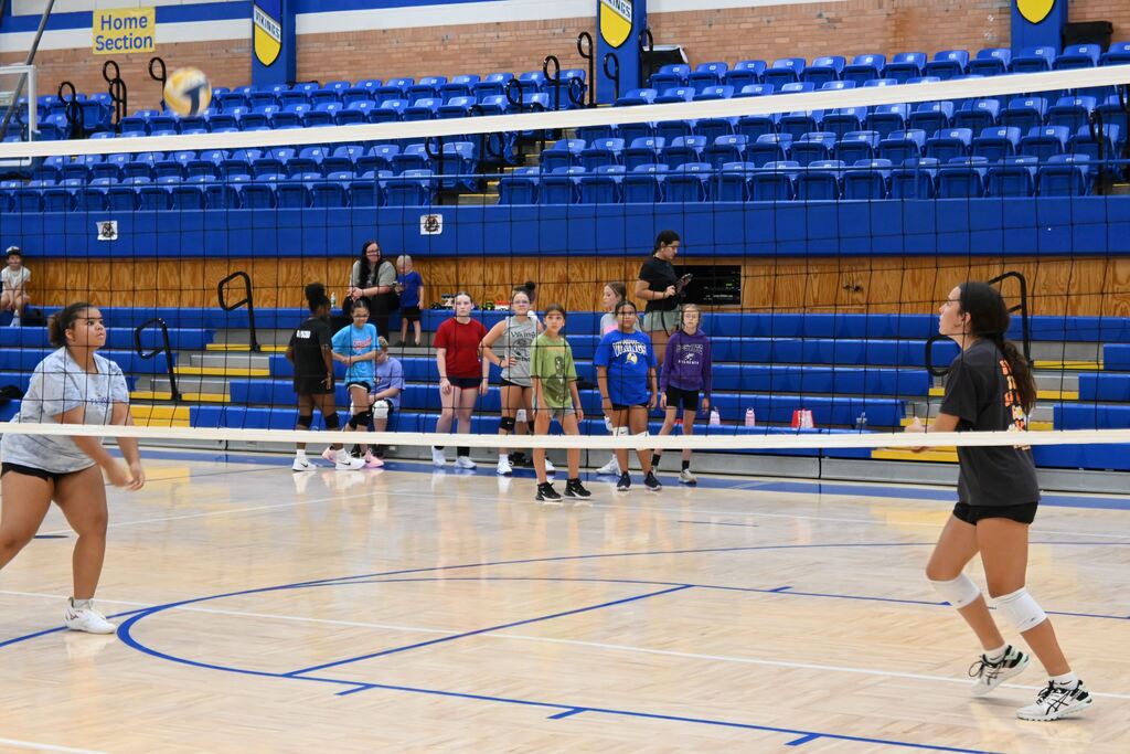 Girls volley the ball learning control.