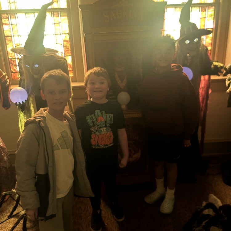 Rhett, Zach, and Mack posing with a Halloween figure 