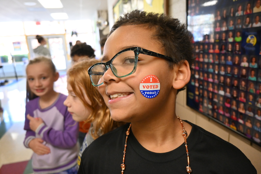 A student proudly displays their I Voted sticker.