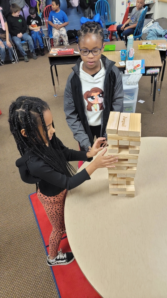 two African American girls working together in the tower building activity