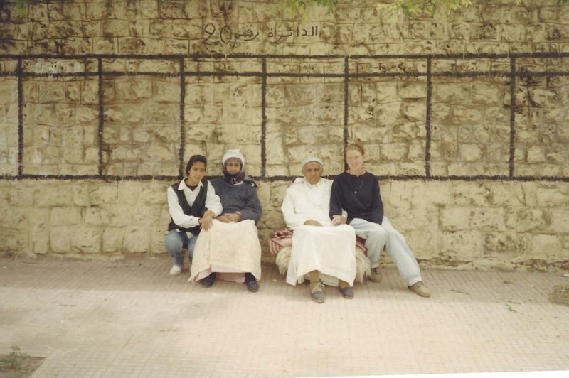Vietti sits in front of an election wall with a family she grew close to in the small village in Morocco.