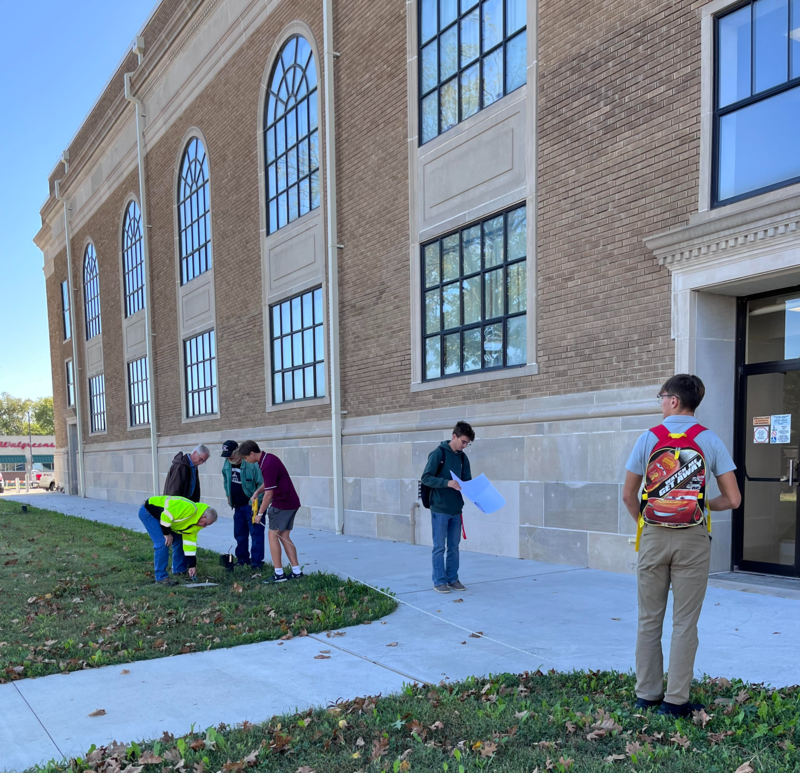 Students work with city officials  regarding electrical line placement.