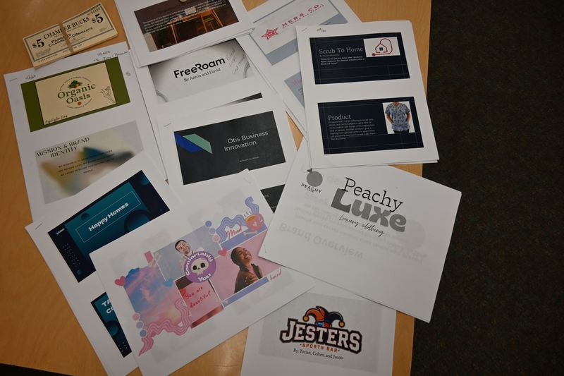 Business plans are spread out on a table.